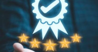 Businessman holding and showing the best quality assurance with golden five stars for guarantee product and ISO service concept.